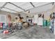 Garage with shelving, bikes, sports equipment, and storage; access door to home at 6168 Pine Bluff Dr, Avon, IN 46123