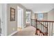 The upstairs hallway overlooks the staircase and has an open doorway to another room at 6168 Pine Bluff Dr, Avon, IN 46123