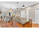 Open-concept kitchen featuring a central island with dark granite countertops and wooden cabinets at 6168 Pine Bluff Dr, Avon, IN 46123