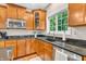 The kitchen features granite counters, stainless steel appliances, and wood cabinets at 6168 Pine Bluff Dr, Avon, IN 46123