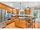 Spacious kitchen boasting stainless steel appliances, dark countertops, and wood cabinets at 6168 Pine Bluff Dr, Avon, IN 46123