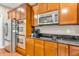 This kitchen features stainless steel appliances, wood cabinets, and an electric cooktop at 6168 Pine Bluff Dr, Avon, IN 46123