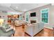 Spacious living room with hardwood floors, a fireplace, and an open layout to the kitchen at 6168 Pine Bluff Dr, Avon, IN 46123