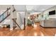 Open-concept living room with hardwood floors, plush seating, and seamless flow to the kitchen at 6168 Pine Bluff Dr, Avon, IN 46123