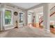 Cozy living room with large windows for natural light and easy access to the entry way and staircase at 6168 Pine Bluff Dr, Avon, IN 46123