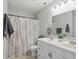Bathroom featuring double sinks, a shower with a paisley curtain and tile flooring at 6552 Hunters S Rdg, Zionsville, IN 46077