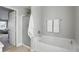 Bright bathroom featuring a shower and soaking tub with white tile and fixtures at 6552 Hunters S Rdg, Zionsville, IN 46077