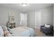 Serene bedroom with a reading chair, neutral decor, and a cozy atmosphere at 6552 Hunters S Rdg, Zionsville, IN 46077