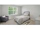 Cozy bedroom with a window view, comfortable seating, and neutral decor at 6552 Hunters S Rdg, Zionsville, IN 46077