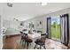 Cozy dining area featuring a white table, black chairs, and seamless access to the backyard through glass door at 6552 Hunters S Rdg, Zionsville, IN 46077