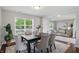Elegant dining room featuring a dark wood table set for six, with bright natural light at 6552 Hunters S Rdg, Zionsville, IN 46077