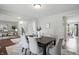 Elegant dining room featuring a dark wood table set for six, with bright natural light at 6552 Hunters S Rdg, Zionsville, IN 46077