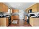 Well-lit kitchen featuring oak cabinets, modern appliances, and hardwood floors at 6552 Hunters S Rdg, Zionsville, IN 46077