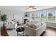 Spacious living room with hardwood floors, fireplace, and plenty of natural light from large windows at 6552 Hunters S Rdg, Zionsville, IN 46077