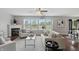 Spacious living room with hardwood floors, fireplace, and plenty of natural light from large windows at 6552 Hunters S Rdg, Zionsville, IN 46077