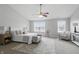 Bright main bedroom features a ceiling fan, a large window, neutral decor and carpeted floors at 6552 Hunters S Rdg, Zionsville, IN 46077