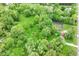Breathtaking aerial view showcasing a verdant landscape with lush trees, a cozy home, and a tranquil setting at 7050 N County Road 650 E, Brownsburg, IN 46112