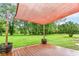 Backyard deck with a canopy, offering shade and views of the expansive, well-manicured lawn at 7050 N County Road 650 E, Brownsburg, IN 46112