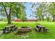 Expansive backyard with a fire pit and picnic tables, perfect for outdoor entertaining at 7050 N County Road 650 E, Brownsburg, IN 46112