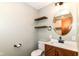 Beautiful bathroom featuring wood vanity, round mirror, open shelving, and shower with glass at 7050 N County Road 650 E, Brownsburg, IN 46112