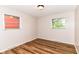 Bedroom with neutral walls, wood-look flooring, and two windows to let in natural light at 7050 N County Road 650 E, Brownsburg, IN 46112
