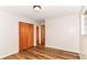 Bedroom with wood-look flooring, natural light, closet, and an entryway at 7050 N County Road 650 E, Brownsburg, IN 46112