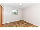 Bright bedroom with wood-look flooring, a window, neutral walls, and a closet door at 7050 N County Road 650 E, Brownsburg, IN 46112