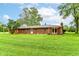 Brick home with a well-maintained lawn and a deck with a canopy, ideal for outdoor relaxation at 7050 N County Road 650 E, Brownsburg, IN 46112