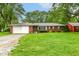 Charming brick ranch-style home with attached garage and well-maintained lawn at 7050 N County Road 650 E, Brownsburg, IN 46112