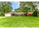 Charming brick ranch-style home featuring an attached garage and a spacious, well-manicured front yard at 7050 N County Road 650 E, Brownsburg, IN 46112
