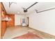 Spacious garage featuring a refrigerator, wood paneling, and ample room for storage at 7050 N County Road 650 E, Brownsburg, IN 46112