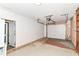 Spacious garage with white door, side door, and overhead lighting for ample visibility at 7050 N County Road 650 E, Brownsburg, IN 46112