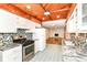Spacious kitchen with stainless steel appliances and view of fireplace in living room at 7050 N County Road 650 E, Brownsburg, IN 46112
