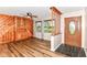 Inviting living room featuring wood paneling, built-in shelving, and hardwood flooring at 7050 N County Road 650 E, Brownsburg, IN 46112