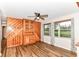 Bright living room with wood paneling, ceiling fan and hardwood floors at 7050 N County Road 650 E, Brownsburg, IN 46112
