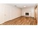 Cozy living room featuring a white brick fireplace and wood-look flooring at 7050 N County Road 650 E, Brownsburg, IN 46112