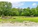 Expansive yard featuring verdant lawns, metal gate, and mature trees, offering a serene and picturesque setting at 7050 N County Road 650 E, Brownsburg, IN 46112