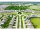 Aerial view of a beautiful neighborhood with lush green spaces and meticulously landscaped roundabouts at 7152 Cherry Creek Blvd, Carmel, IN 46033