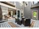 Cozy backyard patio with wicker furniture, string lights, and an open sliding glass door leading indoors at 7152 Cherry Creek Blvd, Carmel, IN 46033