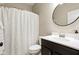 Well-lit bathroom with a white patterned shower curtain, dark cabinets and modern fixtures at 7152 Cherry Creek Blvd, Carmel, IN 46033