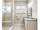 Bathroom with a glass-enclosed shower, granite countertop, and decorative mirror at 7152 Cherry Creek Blvd, Carmel, IN 46033