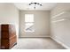 Bright bedroom featuring a large dresser, floating shelves, and a modern light fixture at 7152 Cherry Creek Blvd, Carmel, IN 46033