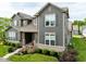Charming two-story home with gray siding, a covered porch, and landscaped yard at 7152 Cherry Creek Blvd, Carmel, IN 46033
