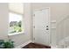 Bright foyer with staircase, window, and front door access at 7152 Cherry Creek Blvd, Carmel, IN 46033
