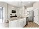 Open kitchen with stainless steel appliances, granite counters, a large island, and access to the living room at 7152 Cherry Creek Blvd, Carmel, IN 46033