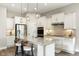Modern kitchen featuring a large island with counter seating, stainless steel appliances, and white cabinetry at 7152 Cherry Creek Blvd, Carmel, IN 46033