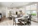 Modern kitchen with white cabinets, stainless steel appliances, and adjacent dining area at 7152 Cherry Creek Blvd, Carmel, IN 46033