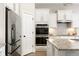 Bright kitchen featuring white cabinets, stainless steel appliances, subway tile backsplash, and granite countertops at 7152 Cherry Creek Blvd, Carmel, IN 46033