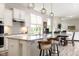 Open kitchen with white cabinets, granite countertops, a large island with seating, and pendant lighting at 7152 Cherry Creek Blvd, Carmel, IN 46033