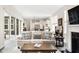 Open-concept living room with modern decor, hardwood floors, fireplace, and adjacent kitchen at 7152 Cherry Creek Blvd, Carmel, IN 46033